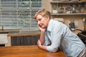 Senior woman leaning on counter