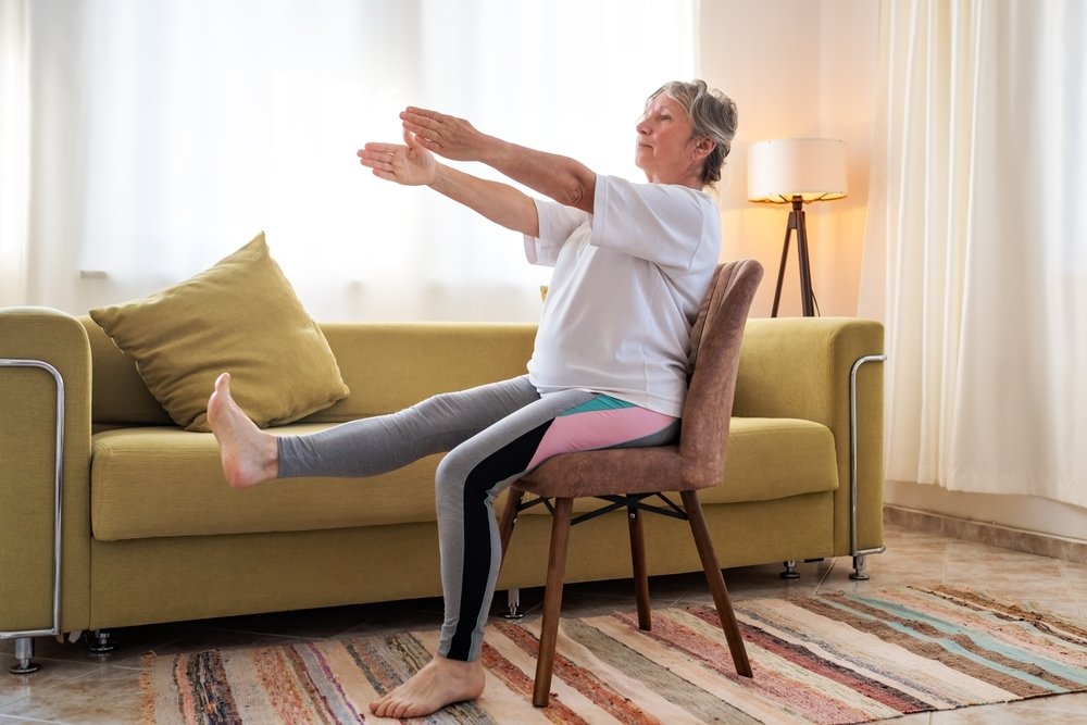 Lady Extending Leg and Arms Sitting on Chair